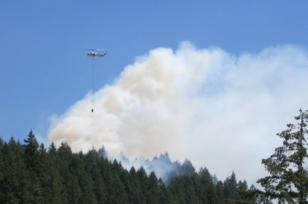 Forest Service helicopter dropping water on Mt. Si fire